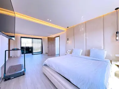 a bedroom with a large white bed in a room at villa Emna Design Contemporain & piscine chauffée in Marrakech