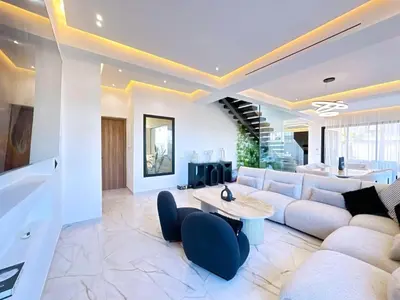 a living room with a couch and a table at villa Emna Design Contemporain & piscine chauffée in Marrakech