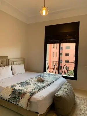 a bedroom with a large bed with a window at chic&Calm appartment in gueliz in Marrakech