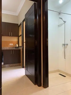 a kitchen with a large glass door in a room at chic&Calm appartment in gueliz in Marrakech