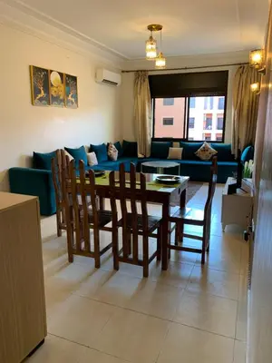 a living room with a table and chairs and a couch at chic&Calm appartment in gueliz in Marrakech