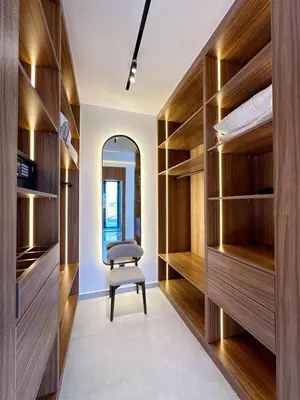 a walk in closet with a chair and a mirror at Modern Villa Assia in Marrakech