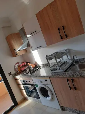 a kitchen with a washing machine and a sink at Habiba in Marrakech