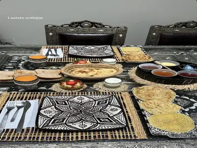 a table full of food and plates of food at Riad zineb au cœur de Marrakech &3 Piscines &Jacuzzi & Petit-Déjeuner& parking gratuit in Marrakech