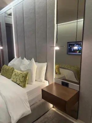 a bedroom with a mirror and a bed and a table at Prestige cocon in Marrakech