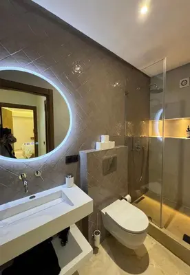 a bathroom with a toilet and a sink and a mirror at Prestige cocon in Marrakech