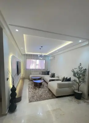 a large living room with couches and a table in it at Prestige cocon in Marrakech