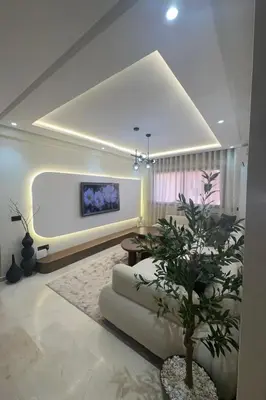 a living room with a couch and a tv at Prestige cocon in Marrakech