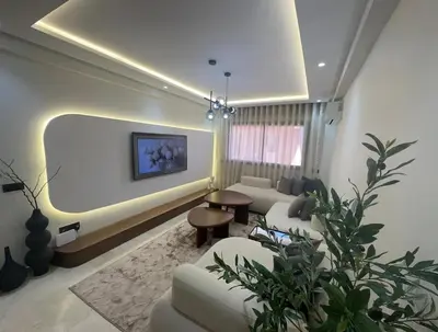 a living room with a couch and a table at Prestige Cocon in Marrakech
