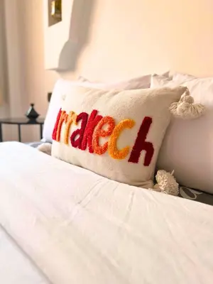 a pillow with the word caleb on a bed at Perle Au cœur de Gueliz avec Piscine et 100m2 in Marrakech