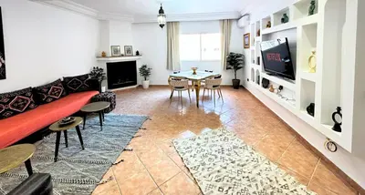 a living room with a couch and a table at Perle Au cœur de Gueliz avec Piscine et 100m2 in Marrakech