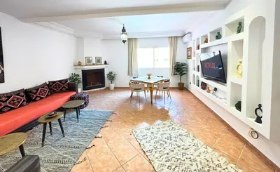 a living room with a couch and a table at Perle Au cœur de Gueliz avec Piscine et 100m2 in Marrakech
