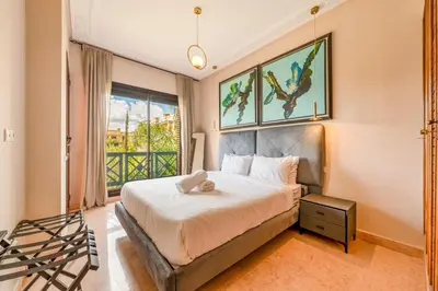 a bedroom with a bed and a window at Cozy Stay with Garden & Pool, 10min to Center in Marrakech