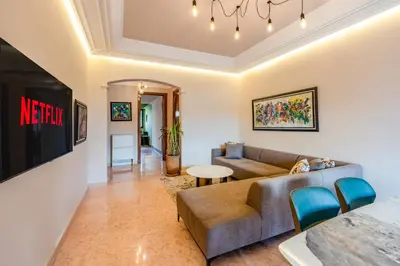 a living room with a couch and a table at Cozy Stay with Garden & Pool, 10min to Center in Marrakech