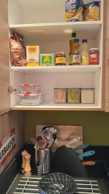 a kitchen pantry with food items on a shelf at Coeur de Marrakech Majorelle 2ch Parking in Marrakech