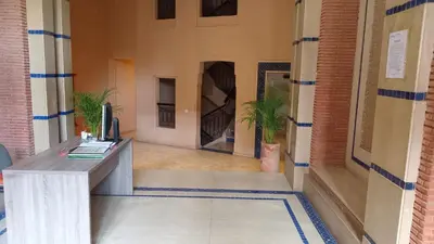 an office with a desk in the middle of a hallway at Coeur de Marrakech Majorelle 2ch Parking in Marrakech