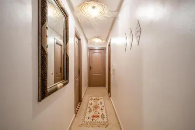 a hallway with a door and a rug on the floor at Appartement Luxe à Marrakech in Marrakech