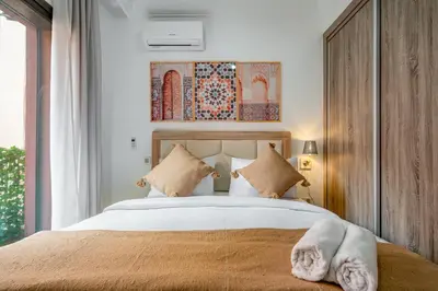 a bedroom with a bed and a large window at Appartement Luxe à Marrakech in Marrakech
