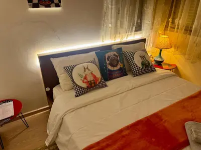 a bedroom with a bed with four pillows on it at Marrakech 3 ch piscine et déco artisanale parfait business et famille in Marrakech