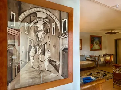 a painting on the wall of a living room at Marrakech 3 ch piscine et déco artisanale parfait business et famille in Marrakech