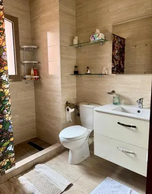 a bathroom with a toilet and a sink at Marrakech 3 ch piscine et déco artisanale parfait business et famille in Marrakech