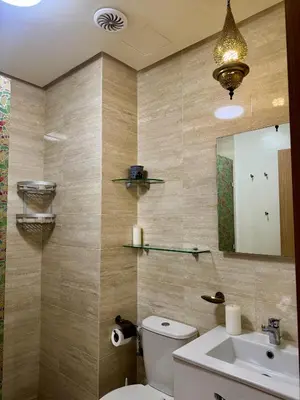 a bathroom with a toilet and a sink and a mirror at Marrakech 3 ch piscine et déco artisanale parfait business et famille in Marrakech