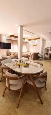 a living room with a table and some chairs at Villa marrakech in Marrakech