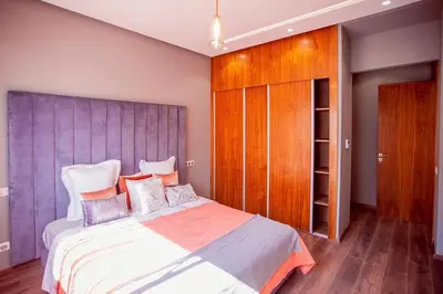 a bedroom with a large bed and a wooden cabinet at Villa marrakech in Marrakech