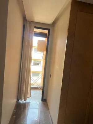 a hallway with a door leading to a window at cozy apartment in Marrakesh in Marrakech