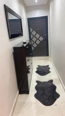 a room with a door and a desk and a mirror at Homesweethome in Marrakech