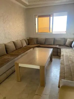 a living room with a couch and a coffee table at Homesweethome in Marrakech