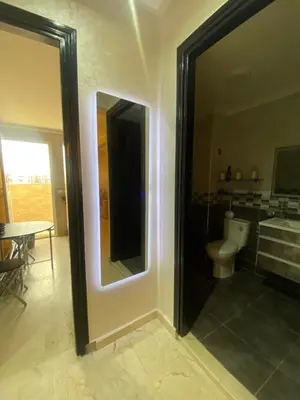 a bathroom with a mirror and a toilet at Homesweethome in Marrakech