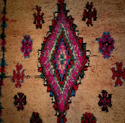 a rug with a colorful design on the floor at Riad Dar el Hachmia - Central private Riad, Air cond, heated pool and Hammam in Marrakech