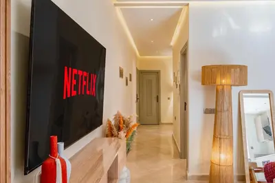 a living room with a television on a wall at Lux & comfort Sunny terrace in Gueliz in Marrakech