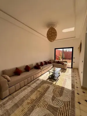 a living room with a couch and a table at Villa Familiale avec Piscine Privée à Marrakech in Marrakech