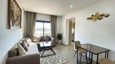 a living room with a couch and a table at Bewelcome in Marrakech