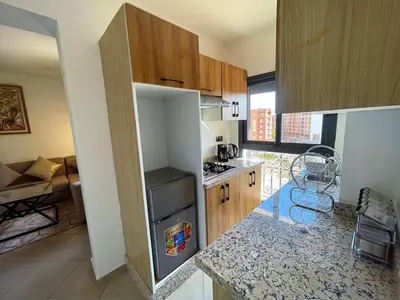 a kitchen with a refrigerator and a counter top at Bewelcome in Marrakech