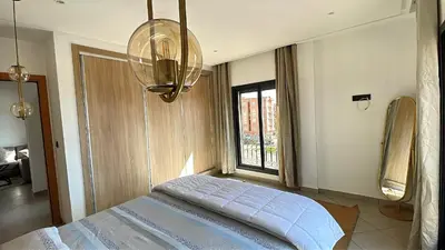 a bedroom with a bed and a window at Bewelcome in Marrakech