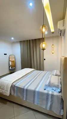 a bedroom with a bed with a blue and white blanket at Bewelcome in Marrakech