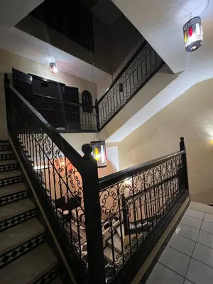 a staircase with a wrought iron railing and lights at Riad Marrakech in Marrakech