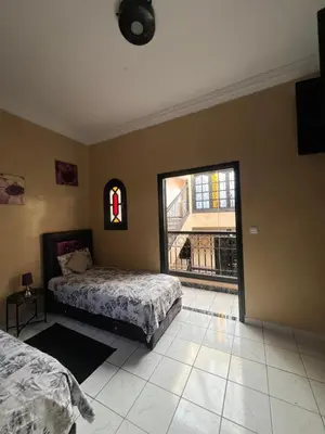 a bedroom with a bed and a large window at Riad Marrakech in Marrakech