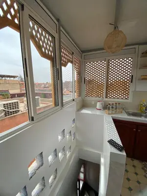 a kitchen with windows and a counter with a sink at Dar Bellaji l Bed & Breakfast in Medina l Rooftop Koutoubia in Marrakech