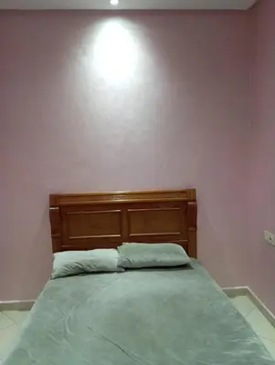 a bedroom with a bed with a light above it at dar immi in Marrakech