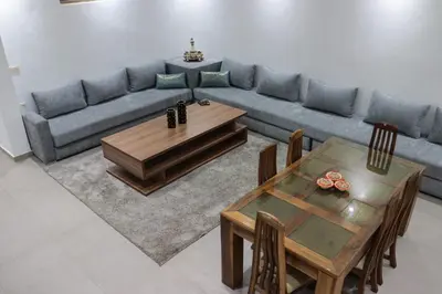 a living room with a couch and a table at appartement 3 chambres gueliz only families in Marrakech