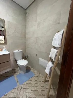 a bathroom with a toilet and a sink at Appartement avec piscine in Marrakech