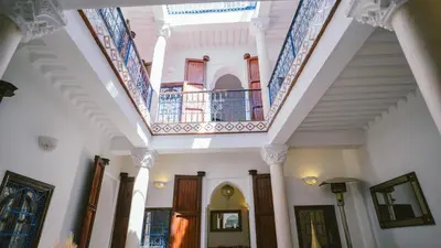 a hallway of a house with blue and white ceilings at Riad KAN ZAMAN in Marrakech