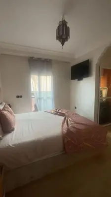 a large bed in a bedroom with a window at Appartement sur Guéliz in Marrakech