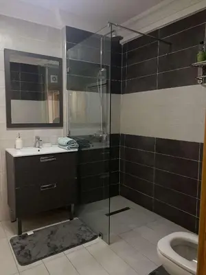 a bathroom with a shower and a sink and a toilet at Appartement sur Guéliz in Marrakech