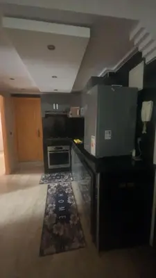 a room with a kitchen with a stove and a counter at Appartement sur Guéliz in Marrakech