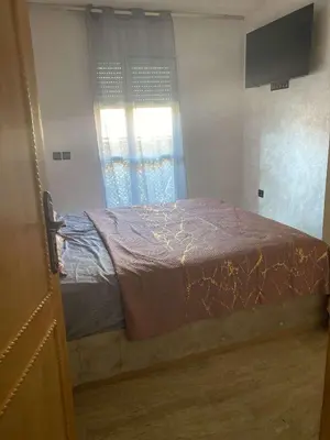 a bed in a room with a window at Appartement sur Guéliz in Marrakech